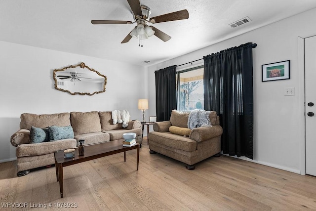 living room featuring light hardwood / wood-style flooring and ceiling fan