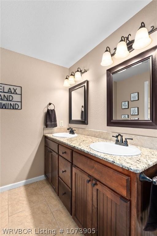 bathroom featuring tile patterned flooring and vanity