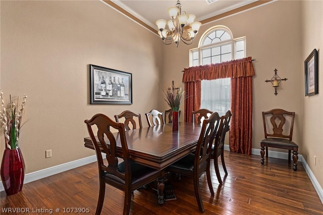 dining room featuring dark wood-type flooring, crown molding, and a notable chandelier