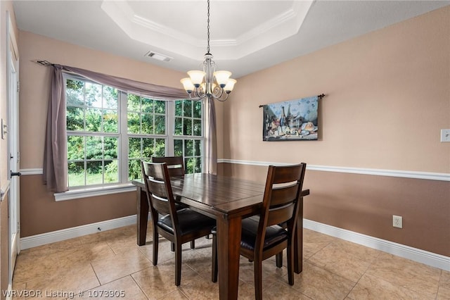 dining area featuring a raised ceiling, light tile patterned floors, ornamental molding, and an inviting chandelier