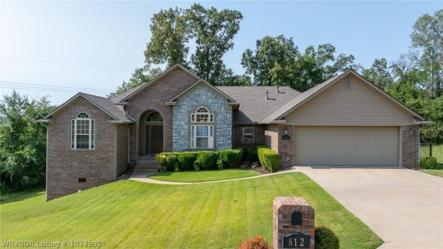 view of front of home with a garage and a front lawn