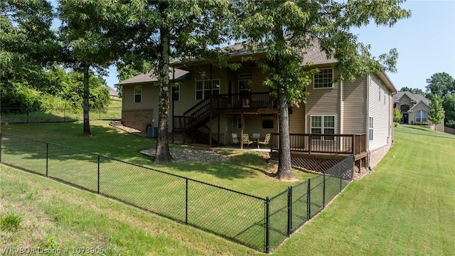 back of property with central AC unit, a lawn, and a wooden deck