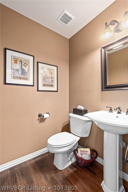 bathroom featuring sink, hardwood / wood-style floors, and toilet