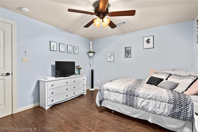 bedroom with ceiling fan and dark wood-type flooring