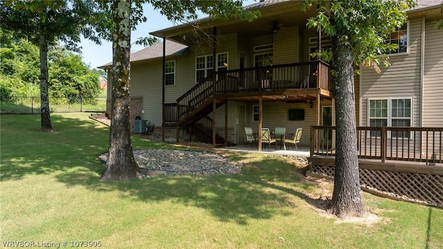 rear view of property with a lawn, a patio area, cooling unit, and a deck