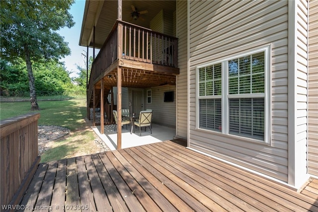 wooden terrace with a lawn and a patio