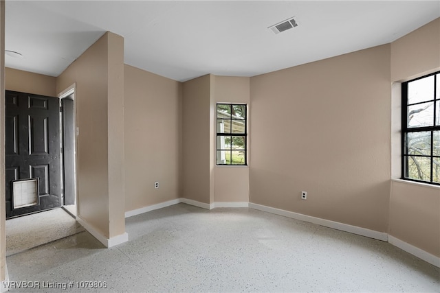 475616 E 1060th Rd, Muldrow, OK 74948 - spare room with plenty of natural light, speckled floor, baseboards, and visible vents