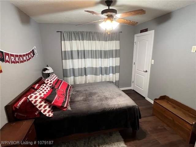 bedroom with ceiling fan and dark wood finished floors