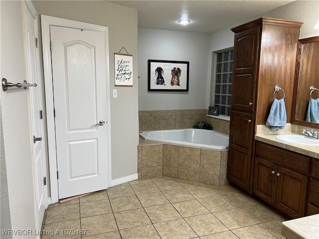 bathroom featuring tile patterned flooring, a garden tub, and vanity