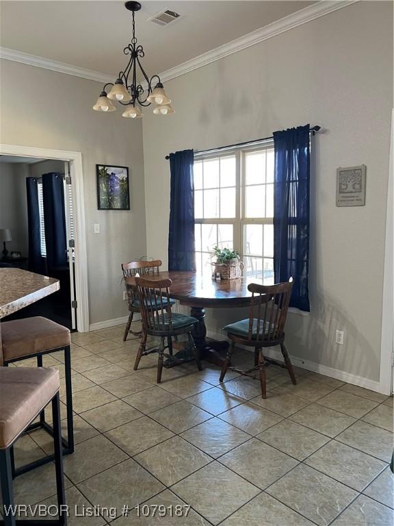 dining room featuring visible vents, baseboards, ornamental molding, a chandelier, and light tile patterned flooring