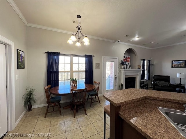 interior space with ornamental molding, a fireplace, baseboards, and light tile patterned floors