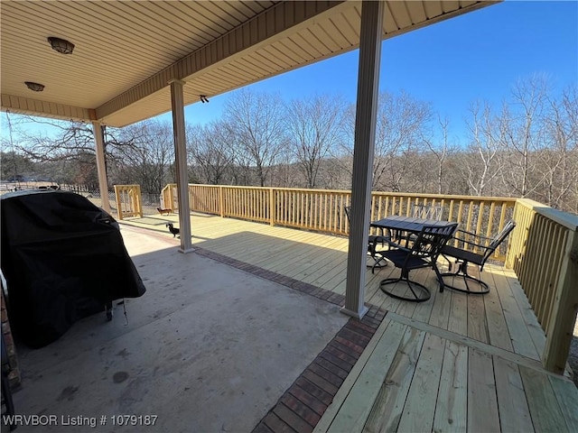 wooden terrace with a grill