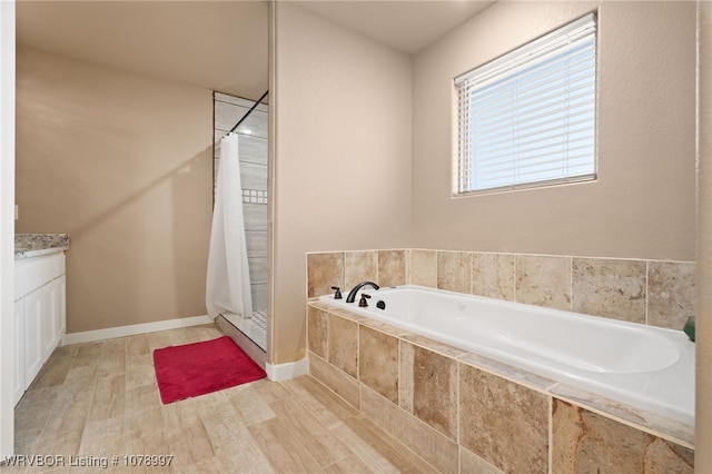 bathroom with plus walk in shower and vanity