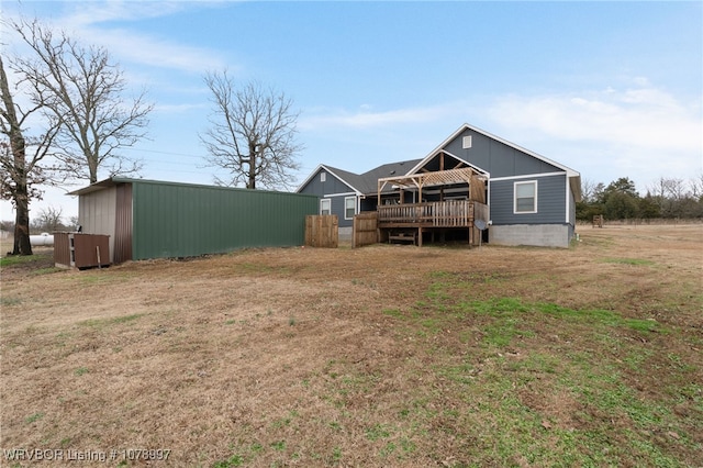 rear view of house featuring a yard