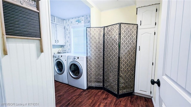 laundry area with washer and clothes dryer, dark hardwood / wood-style flooring, and cabinets