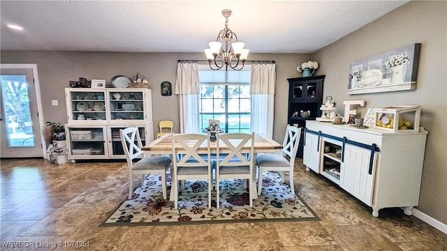 dining area featuring a textured ceiling and an inviting chandelier