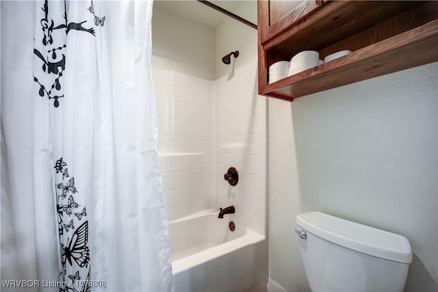 bathroom featuring shower / tub combo and toilet