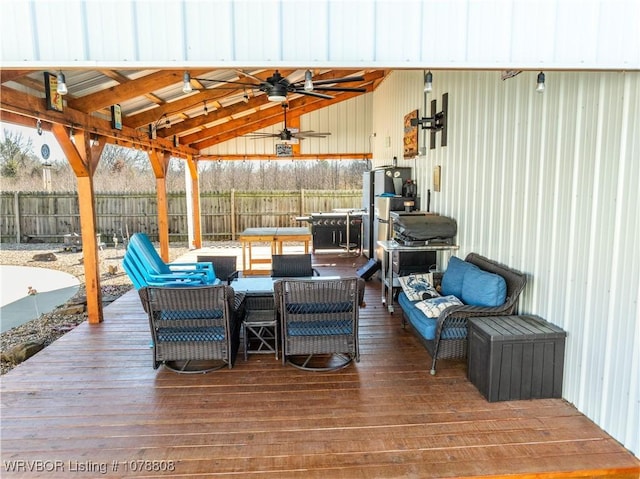 wooden deck with an outdoor living space and ceiling fan