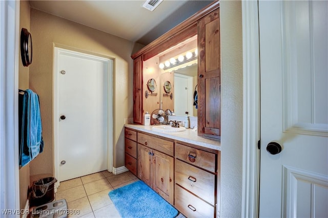 bathroom with tile patterned flooring and vanity