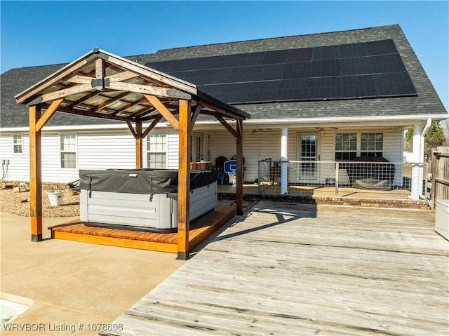 wooden deck with a gazebo and a hot tub