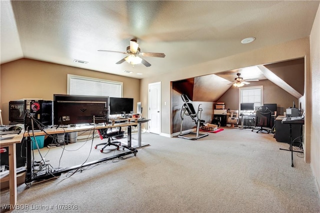 home office with ceiling fan, lofted ceiling, carpet flooring, and a textured ceiling