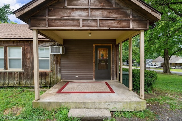 doorway to property with roof with shingles