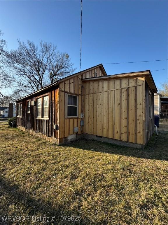 view of property exterior with a yard