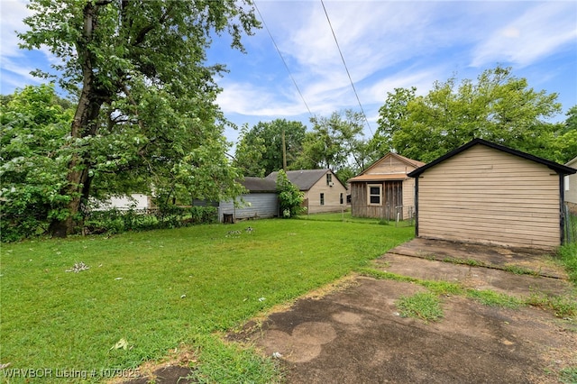 view of yard featuring concrete driveway and fence