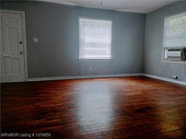 spare room with dark wood-type flooring and cooling unit