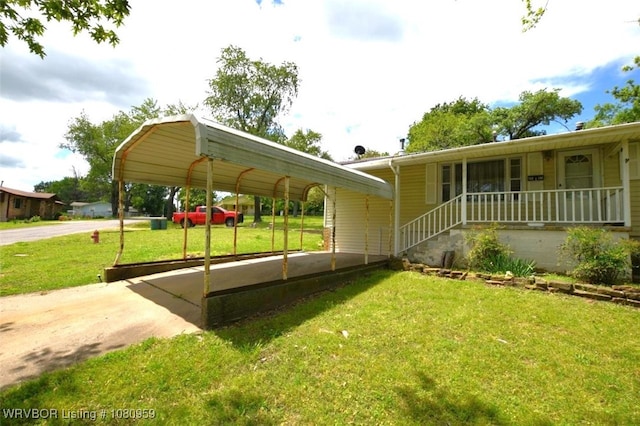 1126 S 2nd St, Stilwell, OK 74960 - view of front facade with a front yard, a carport, and driveway