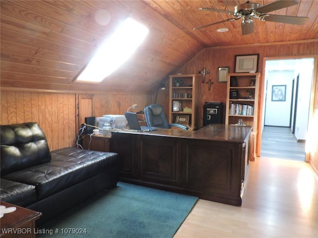 office featuring lofted ceiling, wood walls, wood ceiling, light hardwood / wood-style flooring, and ceiling fan