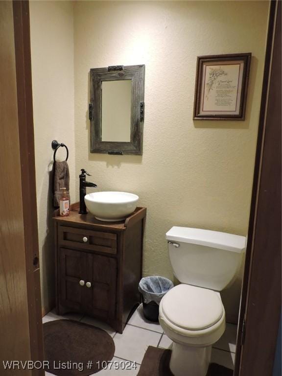 bathroom with vanity, tile patterned floors, and toilet