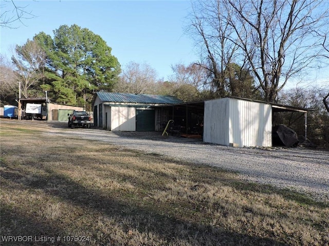 garage featuring a carport and a yard