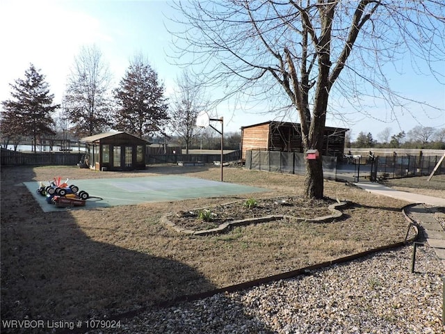 view of yard with basketball hoop