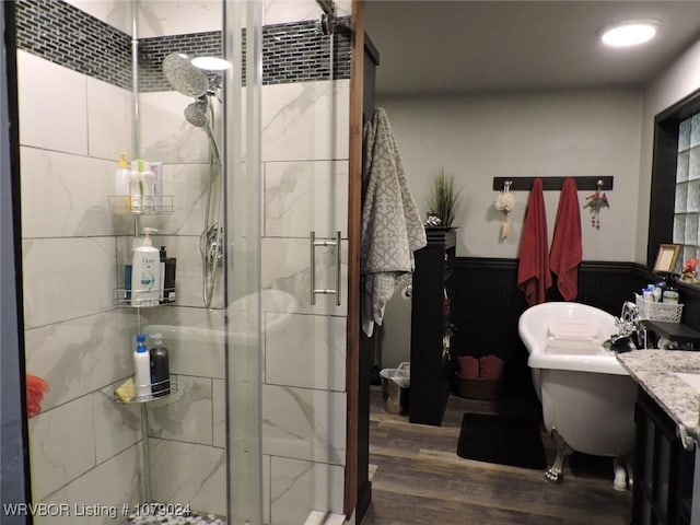 bathroom featuring hardwood / wood-style flooring, vanity, and walk in shower