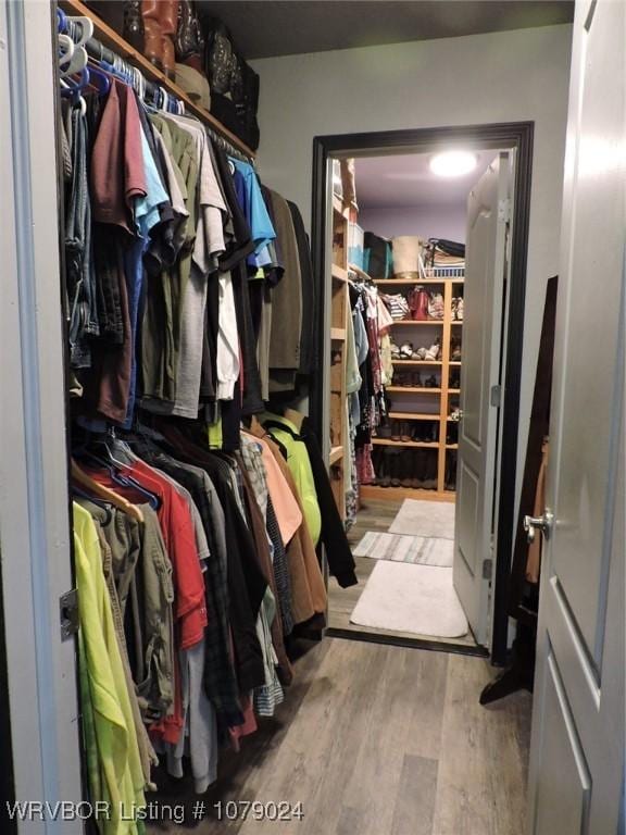 spacious closet with light hardwood / wood-style floors