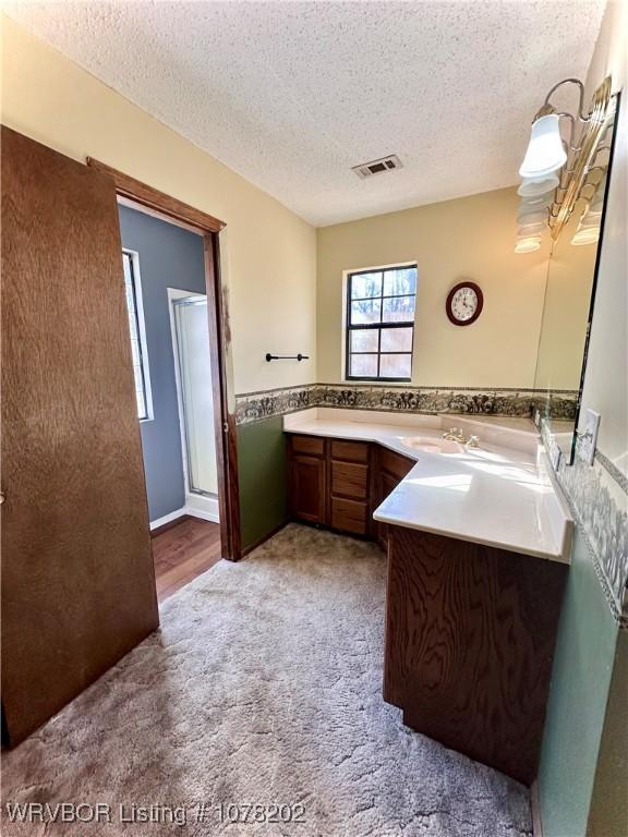 306 Ellis Loop, Pocola, OK 74902 - bathroom with vanity, a textured ceiling, and a shower with door