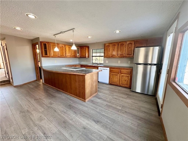 306 Ellis Loop, Pocola, OK 74902 - kitchen featuring dishwasher, sink, stainless steel fridge, light hardwood / wood-style floors, and decorative light fixtures
