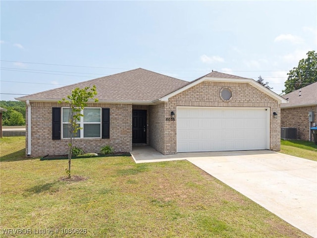 ranch-style house featuring a front yard, brick siding, concrete driveway, an attached garage, and a shingled roof