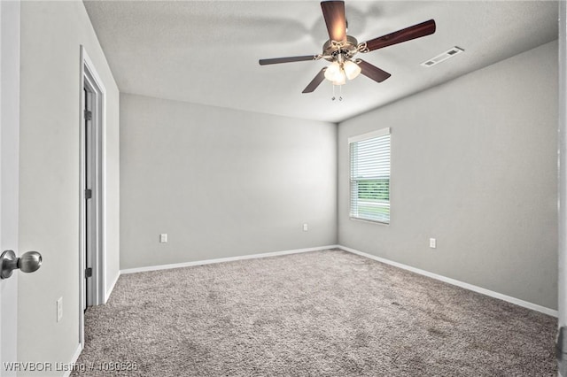 unfurnished bedroom featuring carpet floors, a ceiling fan, baseboards, and visible vents