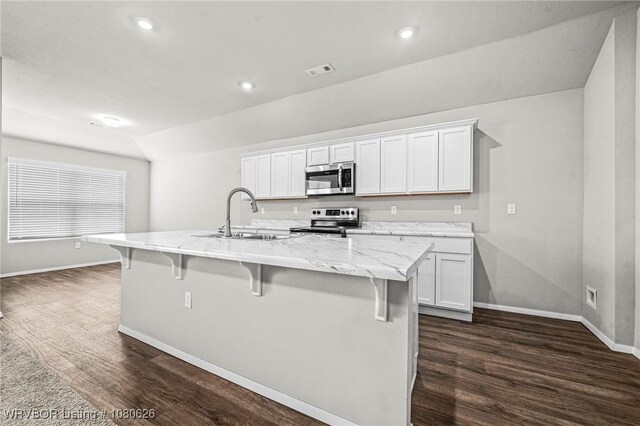 kitchen featuring dark wood-style flooring, baseboards, appliances with stainless steel finishes, and a sink