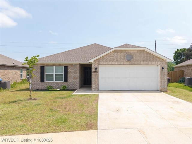 ranch-style home with an attached garage, driveway, cooling unit, and a front lawn