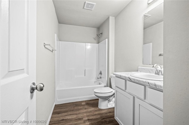 full bath featuring vanity, visible vents, wood finished floors, toilet, and shower / bath combination