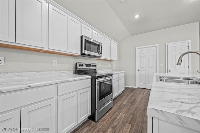 kitchen with white cabinets, dark wood-style flooring, a sink, stainless steel appliances, and lofted ceiling