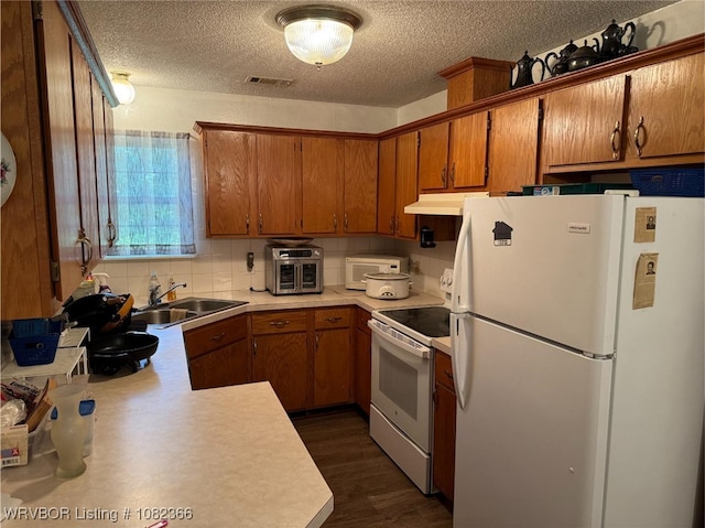 30 Easley Loop, Greenwood, AR 72936 - kitchen with white appliances, brown cabinetry, light countertops, under cabinet range hood, and a textured ceiling