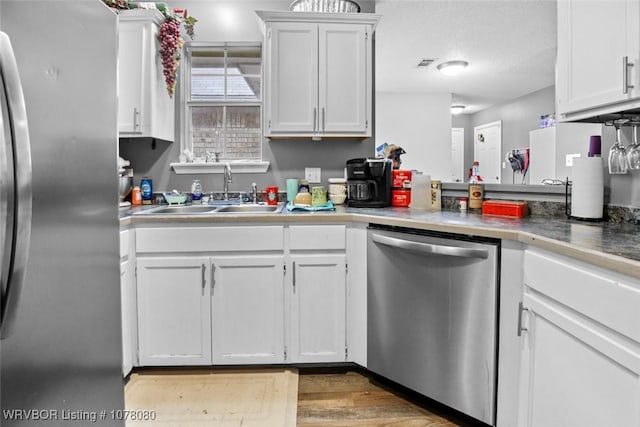 kitchen with white cabinetry, sink, and appliances with stainless steel finishes