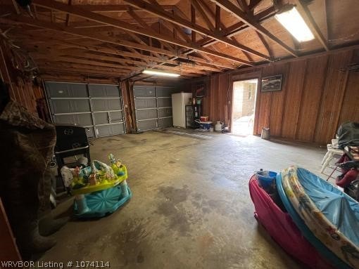 garage with white fridge and water heater