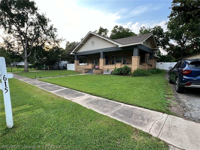 view of front facade featuring covered porch and a front lawn