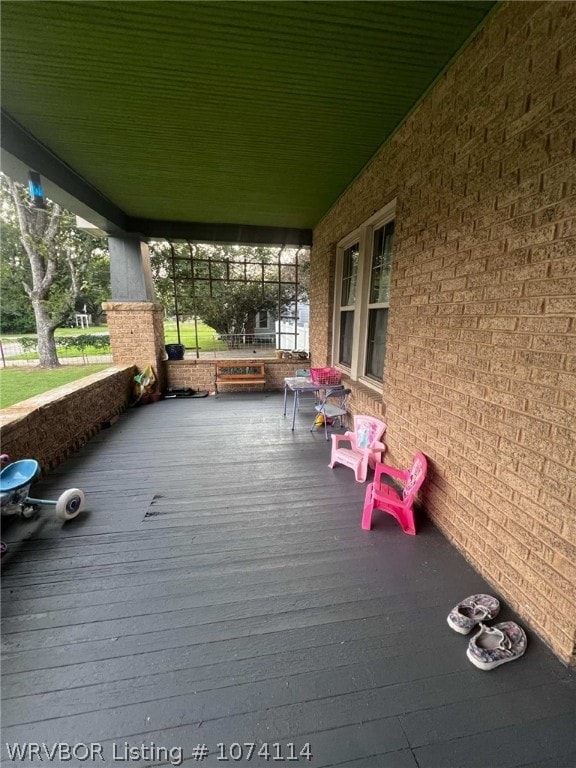 wooden terrace featuring covered porch