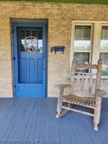 entrance to property featuring a porch